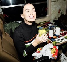 a woman sitting at a table eating food