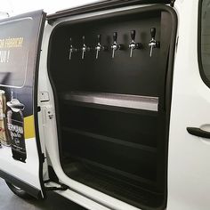 a white van with its door open and beer bottles in it's back compartment