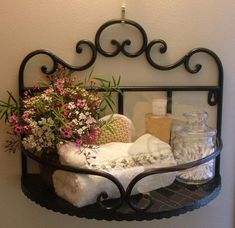 a shelf with towels and flowers on it