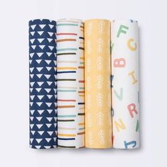 four different types of baby swaddles are lined up in a row on a white background