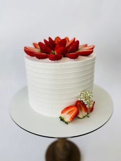 a white cake with strawberries on top