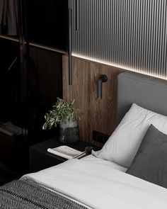 a black and white photo of a bed in a room with wood paneling on the walls