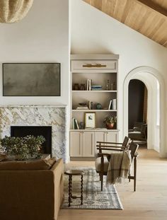 a living room filled with furniture and a fire place