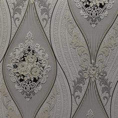 an ornate wallpaper with white flowers and swirls on grey background, closeup