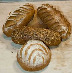 several loaves of bread sitting on top of a counter