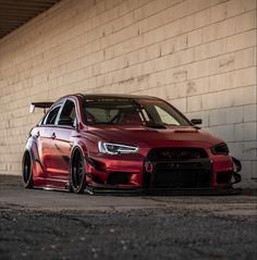 a red car parked in front of a building