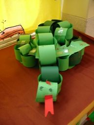 some green and red pieces of paper sitting on a table in front of a mirror