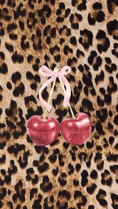 two cherries on a leopard print background