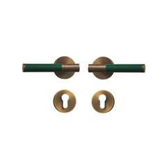 two brass door handles with green handlebars on each side and an open keyhole in the middle