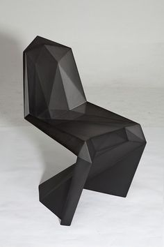 a black chair sitting on top of a white floor