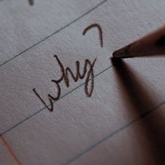 a pencil writing the word sorry on lined paper with brown crayon marker and eraser