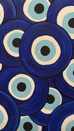 blue and white circles with black dots in the center are shown on a background that looks like it is made out of acrylic paint