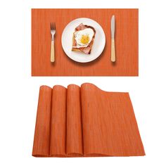 an orange place mat with fork, knife and egg on it next to a white plate