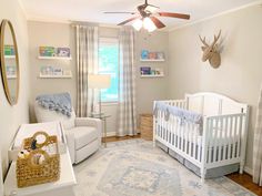 a baby's room with a white crib and blue accents