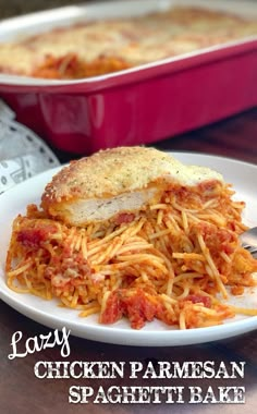 a white plate topped with chicken parmesan spaghetti next to a red casserole dish