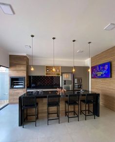 a modern kitchen with an island and bar stools