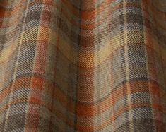 an orange and brown plaid fabric with small squares