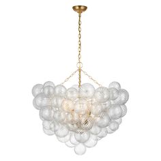 a chandelier with white balls hanging from it's gold chain and light fixture