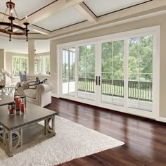 a living room filled with furniture and large sliding glass doors leading to a patio area