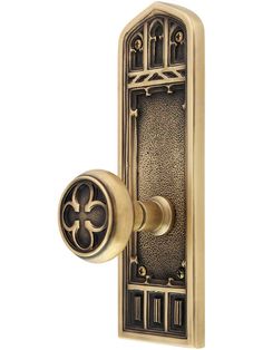 an antique door handle with a decorative design on the front and side panels, in brass