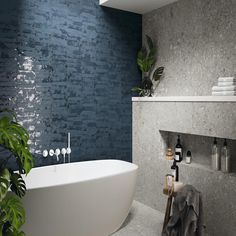 a white bath tub sitting in a bathroom next to a shelf with towels on it