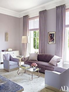 a living room filled with furniture and decor on top of a white floor covered in carpet