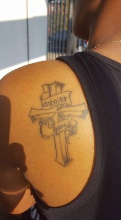 a person with a cross tattoo on their arm