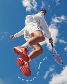 a tennis player jumping in the air with his racket