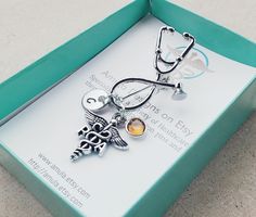 a medical themed necklace in a green box