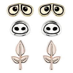 three pairs of earrings with eyes, nose and leaf designs on them in gold and silver