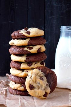 a stack of chocolate chip cookies next to a bottle of milk