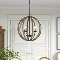 a chandelier hanging over a dining room table