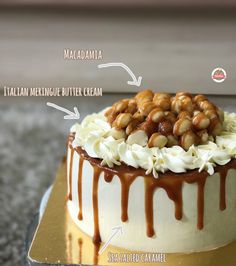 an image of a cake with nuts and cream toppings on the top, including macadamia