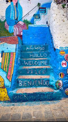 the stairs are painted in different colors and designs, with words written on each step