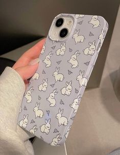 someone is holding up their phone case with rabbits on it