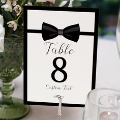 a table number with a bow tie on it