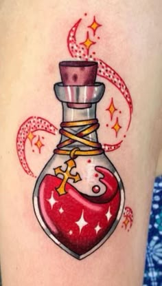 a woman with a tattoo on her arm has a red heart in a glass bottle