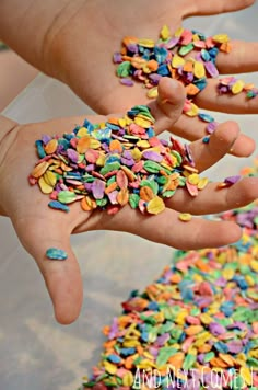 two hands are full of colorful sprinkles