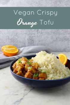 a blue bowl filled with rice and oranges on top of a counter next to an orange slice