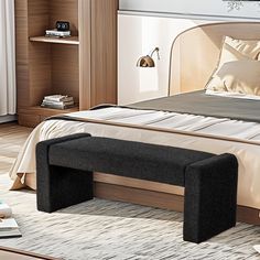 a bed with a bench on top of it next to a nightstand and bookshelf