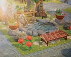 a small pond surrounded by rocks and potted plants next to a wooden bench with succulents on it