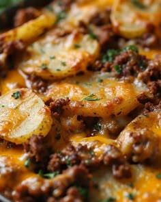 a casserole dish with potatoes, meat and cheese