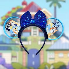 two ears with blue sequins and cartoon characters on them