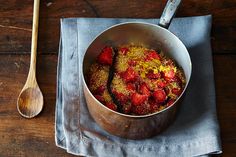 a bowl of strawberries and other food on a table