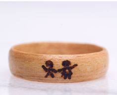 a wooden ring with two little black bears on it