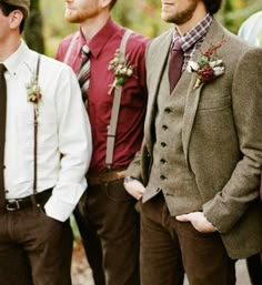 a group of men standing next to each other wearing ties and vests on their heads