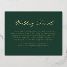 a card with the words wedding details in gold and green on a white marble surface