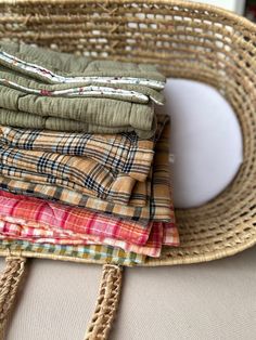 a wicker basket filled with cloths on top of a table