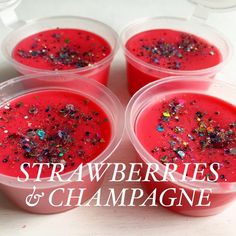 four plastic cups filled with red liquid and sprinkles