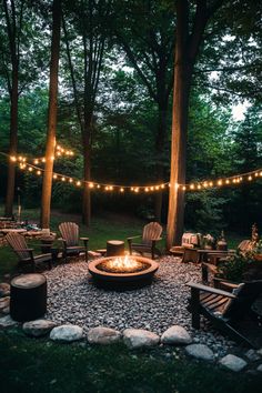 String lights above a fire pit surrounded by Adirondack chairs in a wooded backyard setting. Landscape Ideas Fire Pit, Smaller Backyard Ideas, Backyard And Deck Ideas, Backyard Cottage Ideas, Pnw Backyard Landscaping, Landscaping Wooded Backyard, Backyard In The Woods, Backyard For Teens, Outside Patio Ideas On A Budget